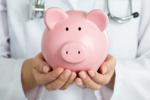 Stableford health care financial plan medigap - Female Doctor Holding Piggy Bank