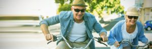 mature couple riding bikes stress free with annuities financial investment strategy in place - Stableford