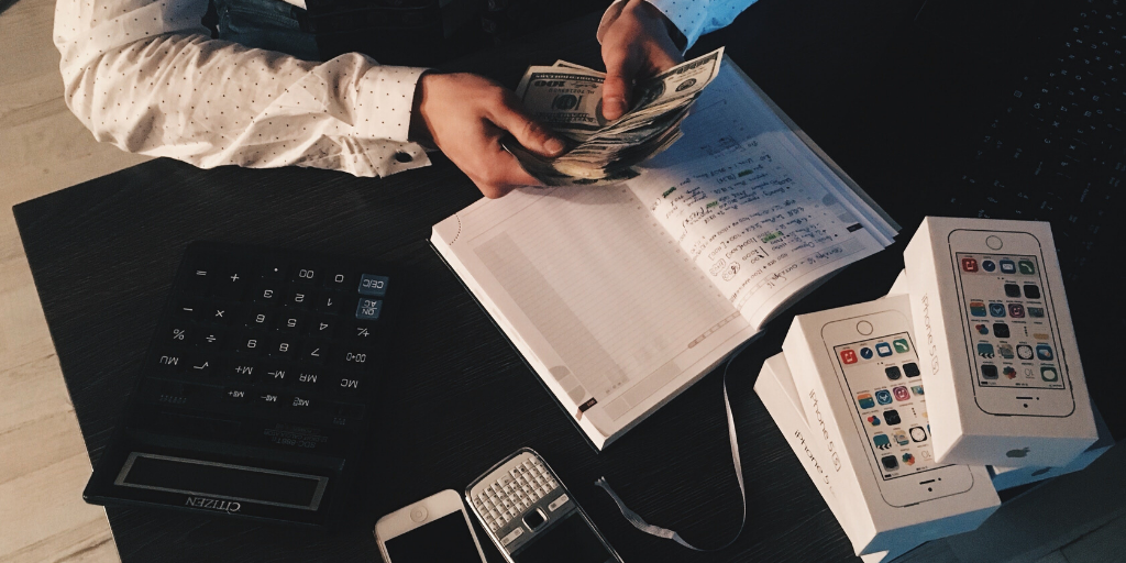 man with notebook, calculators and money for how to find a financial advisor stableford blog