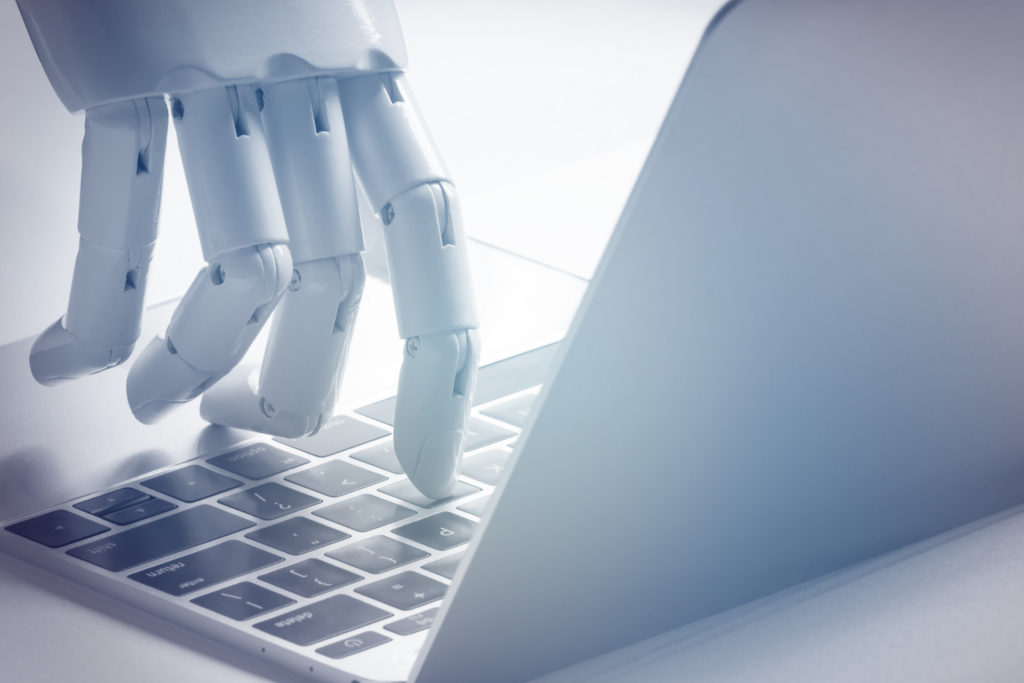 Artificial Intelligence Disruption with robotic finger typing on laptop Stableford Capital