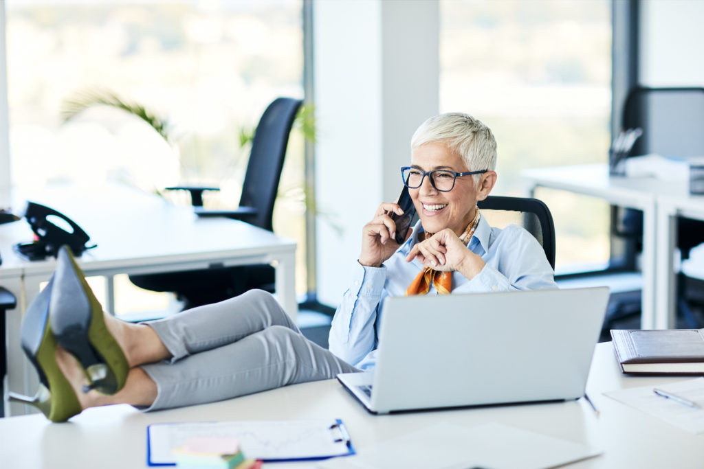 business woman casually dressed in office with laptop for women investors - stableford