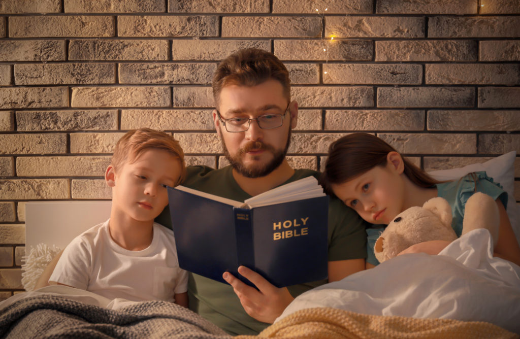 As part of an ethical you will you can pass down meaningful details - such this photo of a father reading the bible to his kids in bed