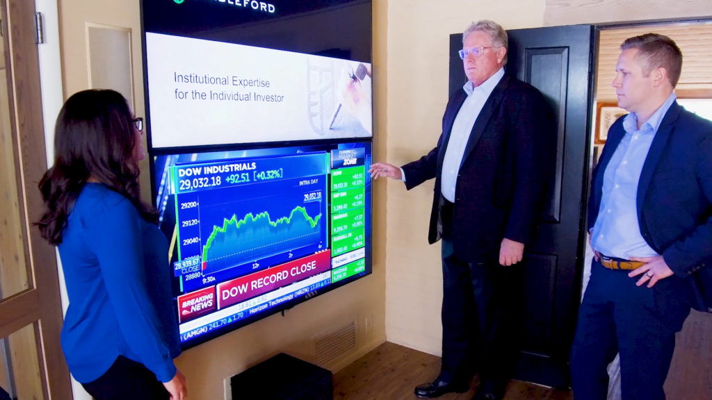 Stableford's investment experience with 3 financial advisors watching the market close on screen