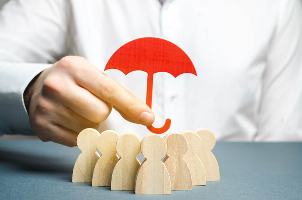 Leverage Life Insurance man holding small red umbrella over wooden cutouts of family - Stableford
