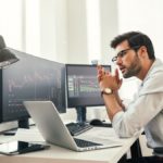 Growth vs Value Stocks - trader looking at analyzing trading charts - web