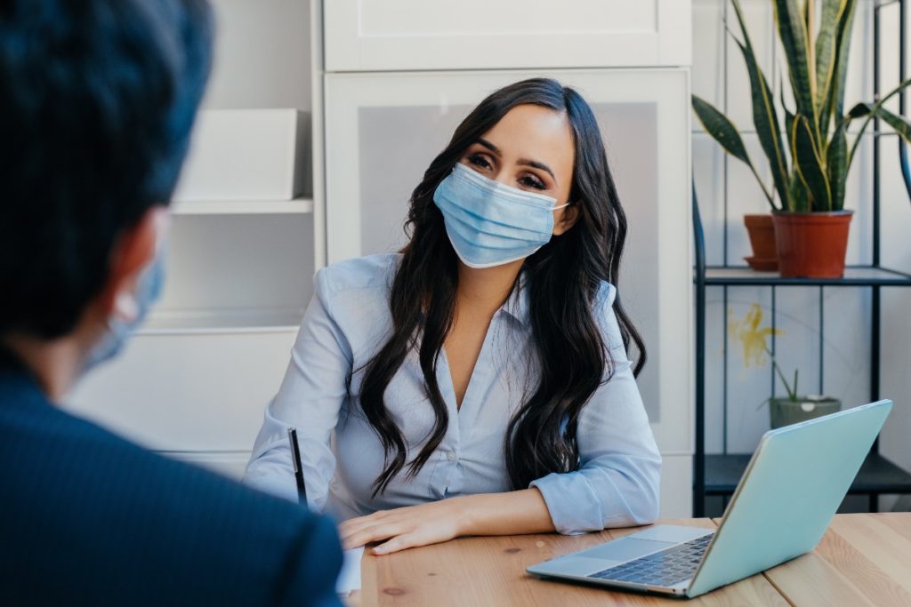 Yield Curve Control with business woman with client wearing mask due to pandemic - Stableford-web