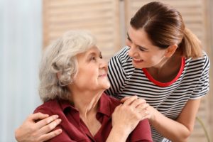 Elderly Woman with Alzheimer's with female caregiver-web