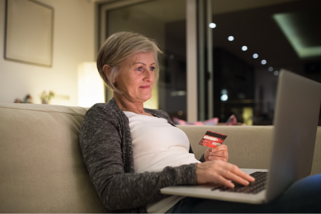 Senior woman with laptop investing Alzheimer's expenses - Stableford-web