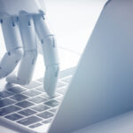 Artificial Intelligence Disruption with robotic finger typing on laptop Stableford Capital